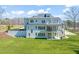 The back of the home features a large screened in porch with access to the backyard and patio at 40 Park Meadow Ln, Youngsville, NC 27596