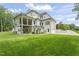 Expansive backyard featuring a covered porch, exterior features and lush green lawn, perfect for outdoor entertaining at 40 Park Meadow Ln, Youngsville, NC 27596