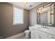 Powder room featuring wallpaper and a white vanity with a decorative mirror at 40 Park Meadow Ln, Youngsville, NC 27596