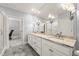 Bathroom with granite countertops, double sinks, and a large mirror at 40 Park Meadow Ln, Youngsville, NC 27596