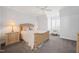 Well-lit bedroom features a ceiling fan, neutral walls, carpet flooring, and comfortable seating at 40 Park Meadow Ln, Youngsville, NC 27596