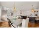 Bright dining area features a stylish chandelier and is adjacent to the modern kitchen with two islands at 40 Park Meadow Ln, Youngsville, NC 27596