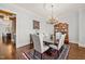 Elegant dining room with hardwood floors, chandelier, and seating for six at 40 Park Meadow Ln, Youngsville, NC 27596