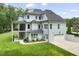 Beautiful exterior view showcasing the home's architectural design, manicured lawn, and attached two car garage at 40 Park Meadow Ln, Youngsville, NC 27596