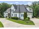 Stylish two-story home with blue siding, dark shutters, attached garage, and beautifully maintained landscaping at 40 Park Meadow Ln, Youngsville, NC 27596