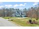 Lovely home featuring stone accents, an attached garage, and a sprawling front yard with mature trees at 40 Park Meadow Ln, Youngsville, NC 27596