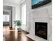 Ornate fireplace with white marble surround, decorative mantle, and adjacent window with natural light at 40 Park Meadow Ln, Youngsville, NC 27596