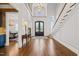 A grand foyer with high ceilings, a staircase, and a view into the dining room at 40 Park Meadow Ln, Youngsville, NC 27596