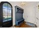 Charming foyer with blue mudroom bench, hardwood floors and black front door at 40 Park Meadow Ln, Youngsville, NC 27596