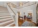 Grand foyer featuring a staircase, chandelier, and dining room with elegant furnishings at 40 Park Meadow Ln, Youngsville, NC 27596