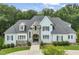 Charming home features a stone and brick entrance, a blue facade, and a well-manicured front yard at 40 Park Meadow Ln, Youngsville, NC 27596