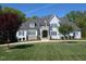 Stately home with lush lawn, stone accents, and charming architectural details at 40 Park Meadow Ln, Youngsville, NC 27596