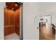 Hallway featuring wood-paneled elevator and doorway to an open living space at 40 Park Meadow Ln, Youngsville, NC 27596