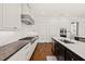 Bright kitchen featuring white cabinets, herringbone backsplash, and hardwood flooring at 40 Park Meadow Ln, Youngsville, NC 27596