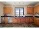 Eat-in kitchen with wood cabinets, stainless steel appliances, dark counters, and slate floors at 40 Park Meadow Ln, Youngsville, NC 27596