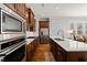 Modern kitchen with stainless steel appliances, marble countertops, and warm wood cabinets at 40 Park Meadow Ln, Youngsville, NC 27596