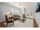 Elegant living room with French doors, plantation shutters, and plush seating at 40 Park Meadow Ln, Youngsville, NC 27596
