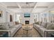Bright living room with a fireplace, large windows, hardwood floors, and coffered ceiling at 40 Park Meadow Ln, Youngsville, NC 27596