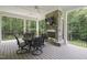 Covered deck boasts a stone fireplace with tv, creating a cozy and inviting outdoor living space at 40 Park Meadow Ln, Youngsville, NC 27596