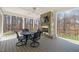 Covered outdoor living space includes a stone fireplace, ceiling fan, and wooded views at 40 Park Meadow Ln, Youngsville, NC 27596
