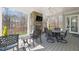 Covered patio featuring stone fireplace, wooded views, and outdoor seating area at 40 Park Meadow Ln, Youngsville, NC 27596