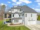 Rear exterior of house showing covered porch, balcony, large yard and three-car garage at 40 Park Meadow Ln, Youngsville, NC 27596