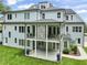 Stunning rear view of the home with a covered patio, stone fireplace, and multi-level balconies at 40 Park Meadow Ln, Youngsville, NC 27596