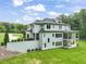 Back exterior featuring a covered patio, upper balconies, and beautifully landscaped yard at 40 Park Meadow Ln, Youngsville, NC 27596