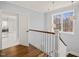 Bright stairwell landing boasts hardwood floors, large windows and decorative starburst light fixtures at 40 Park Meadow Ln, Youngsville, NC 27596