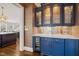 Stylish wet bar featuring custom cabinetry, marble countertop, and wine refrigerator at 40 Park Meadow Ln, Youngsville, NC 27596