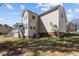 Expansive backyard showcasing the home's exterior with a screened porch and lush greenery at 400 Oxford Park Blvd, Oxford, NC 27565