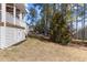 Picturesque backyard featuring mature trees, a well-manicured lawn, and a glimpse of the home's exterior at 400 Oxford Park Blvd, Oxford, NC 27565
