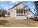 Generous backyard area highlighting a covered patio, well-kept lawn, and the home's siding at 400 Oxford Park Blvd, Oxford, NC 27565