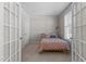 Cozy bedroom with neutral walls, a patterned bedspread, and bright natural light from the window at 400 Oxford Park Blvd, Oxford, NC 27565