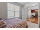 Comfortable bedroom with large windows, soft carpet, and a view into a bright adjacent room at 400 Oxford Park Blvd, Oxford, NC 27565