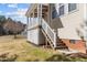 A covered patio featuring a ceiling fan, white railing, and access to backyard, ideal for outdoor enjoyment at 400 Oxford Park Blvd, Oxford, NC 27565