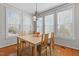 Bright dining room with a wooden table, chandelier, rug, and natural light from the many windows at 400 Oxford Park Blvd, Oxford, NC 27565