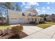 Attractive home featuring a three-car garage, a covered front porch, and a well-maintained lawn at 400 Oxford Park Blvd, Oxford, NC 27565