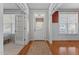 Bright foyer featuring hardwood floors, white trim, and a classic front door with sidelights at 400 Oxford Park Blvd, Oxford, NC 27565