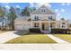 Charming home with a well-manicured lawn, inviting porch, and a spacious three-car garage at 400 Oxford Park Blvd, Oxford, NC 27565