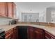 Kitchen featuring dark wood cabinets, light countertops, stainless steel appliances, and natural lighting at 400 Oxford Park Blvd, Oxford, NC 27565