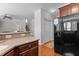 Kitchen area featuring dark cabinets, light countertops, stainless steel appliances, and an adjacent stairwell at 400 Oxford Park Blvd, Oxford, NC 27565
