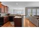 Well-lit kitchen area with wood cabinets, quartz countertops, and stainless steel appliances at 400 Oxford Park Blvd, Oxford, NC 27565