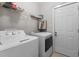 Bright laundry room featuring a washing machine, dryer, and door to another part of the home at 400 Oxford Park Blvd, Oxford, NC 27565