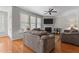 Comfortable living room featuring a fireplace, ceiling fan, hardwood floors, and natural light from the many windows at 400 Oxford Park Blvd, Oxford, NC 27565