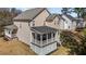 A home's rear exterior featuring an elevated screened porch and a well-manicured lawn at 400 Oxford Park Blvd, Oxford, NC 27565