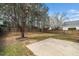 Backyard with mature trees, lawn, patio, and wooden fence, creating a serene outdoor space at 406 Homestead Park Dr. Dr, Apex, NC 27502