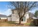 Picture of house's backyard with large tree, green lawn, wooden fence, and patio at 406 Homestead Park Dr. Dr, Apex, NC 27502