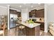 Modern kitchen with granite counters, stainless appliances, dark cabinets, and center island with bar stool seating at 420 Retreat Ln, Wake Forest, NC 27587