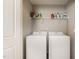 Convenient laundry room equipped with a washer, dryer, and shelving for storage at 420 Retreat Ln, Wake Forest, NC 27587